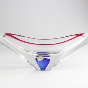 May include: A clear glass bowl with a pink rim and a blue and gold glass accent at the bottom.