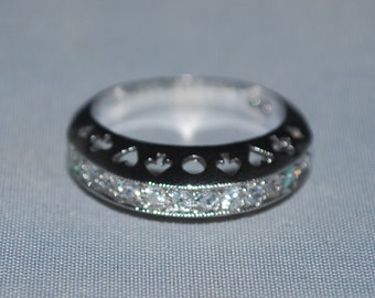 Sterling silver band ring size 8.75 with cubic zirconium setting.