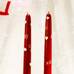 red taper candles with white hearts and pink xo