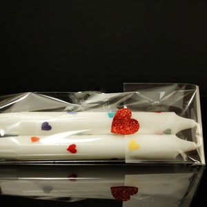 Valentine's day Pride candles wrapped in cellophane.