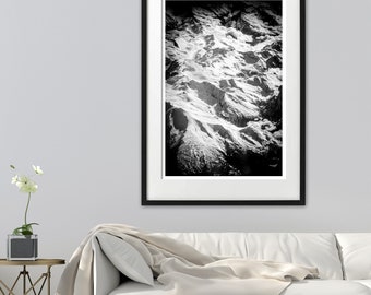 May include: Black and white photograph of a snow-covered mountain range. The image is framed in a black frame with a white mat.