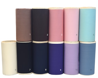 May include: Eleven rolls of fabric in various colors, including beige, brown, pink, light blue, navy blue, dark blue, purple, and light blue. Each roll is numbered 1 through 11.