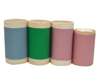 May include: Four rolls of fabric tape, each with a different color: light blue, green, pink, and a darker pink. The rolls are all the same size and have a white label on the end.