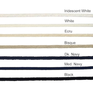 May include: A close-up of seven different colors of cord, from top to bottom: Iridescent White, White, Ecru, Bisque, Dark Navy, Medium Navy, and Black.