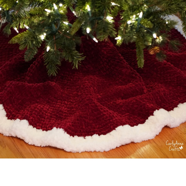 May include: A red velvet Christmas tree skirt with a white fluffy trim. The skirt is made of a soft, plush fabric and is perfect for adding a touch of elegance to your holiday decor.