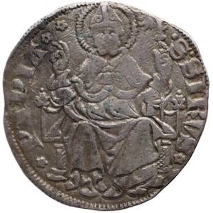 May include: A silver coin featuring a seated figure with a halo, holding a staff and a floral emblem. The coin has an ornate border with floral designs and text around the edge. The coin appears to be an antique.