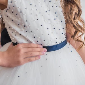 Closeup of a white navy beaded dress