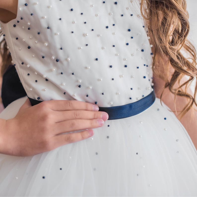 Closeup of a white navy beaded dress