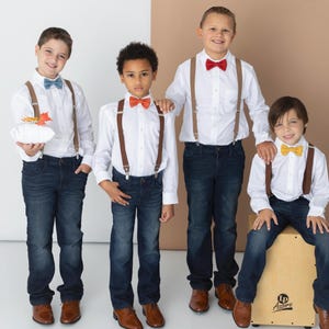Boys wearing a variety of Armoniia bow ties and suspenders including steel blue bow tie