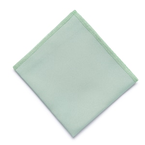 May include: A light green square fabric napkin with a light green stitched border.