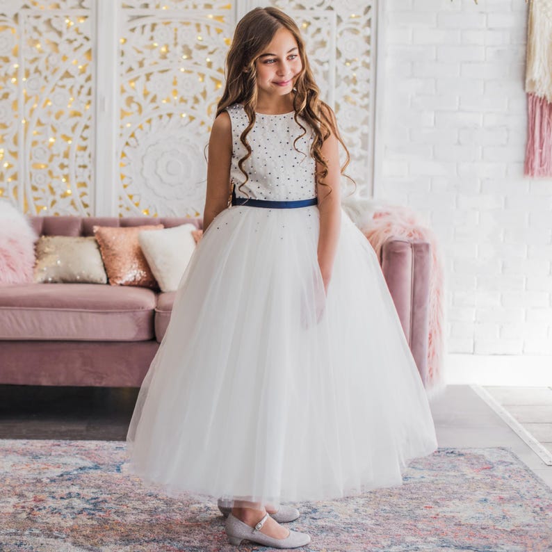 Girl in a white navy beaded dress
