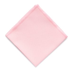May include: A light pink square fabric napkin with a white border.