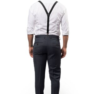 Back of man wearing black suspenders