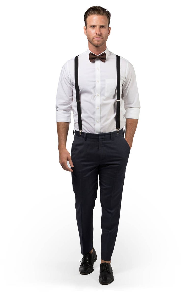 Man wearing black suspenders & brown bow tie