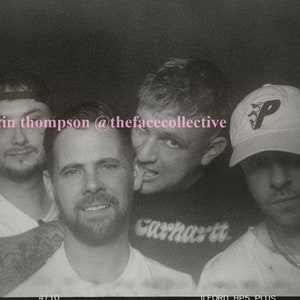 May include: Black and white photo of four people. Three of the people are wearing white t-shirts. One person is wearing a black shirt with the word "Carhartt" written on it. One person is wearing a white baseball cap with a black "P" on it. The photo is captioned "©martin thompson @thefacecollective".
