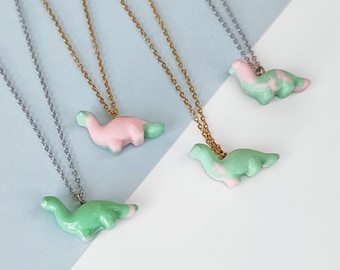 Necklace with green and pink diplodocus pendant