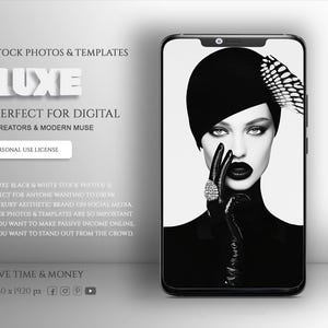 May include: Black and white photograph of a woman wearing a black hat and gloves, with a feather detail. The photo is displayed on a smartphone screen. The text "LUXE" is displayed above the phone screen.