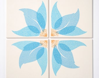 May include: Four white square tiles with a blue floral design. Each tile features a quarter of the flower, with the four tiles forming a complete flower.