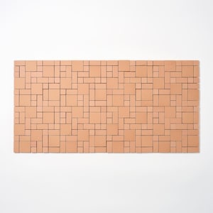 May include: A rectangular, terracotta-colored tile panel with a geometric pattern. The design features an arrangement of various-sized squares and rectangles, creating a mosaic-like appearance. The tiles are arranged in a grid-like fashion.