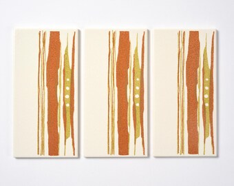 May include: Three rectangular panels with a white background and a repeating pattern of vertical orange and yellow lines. The lines are abstract and resemble brushstrokes.