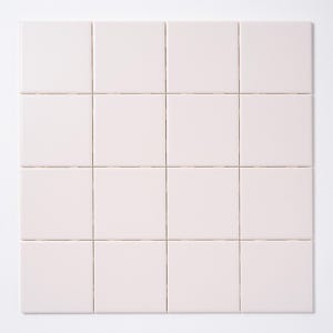 May include: A grid of sixteen square, pale pink tiles arranged in four rows and four columns. The tiles have a smooth, matte finish and are evenly spaced with thin grout lines. The background is plain white.