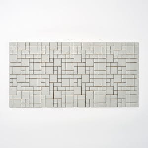 May include: A rectangular, off-white tile mosaic with a geometric pattern of varying square and rectangular shapes. The mosaic is composed of numerous small, light-colored tiles separated by thin, dark lines, creating a modern, abstract design.