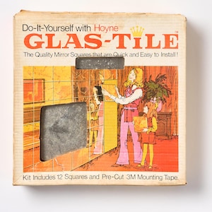 May include: A box for a DIY mirror tile kit called "Glas-Tile" by Hoyne. The box features a colorful illustration of a woman and a child installing the tiles. The text on the box reads "Do-It-Yourself with Hoyne Glas-Tile. The Quality Mirror Squares that are Quick and Easy to Install! Kit Includes 12 Squares and Pre-Cut 3M Mounting Tape."