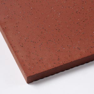May include: A close-up of a red textured tile with a slightly rough surface.