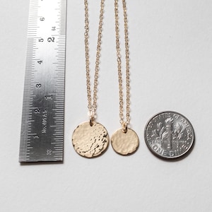 Both necklaces are shown next to a ruler and a dime, for size reference.