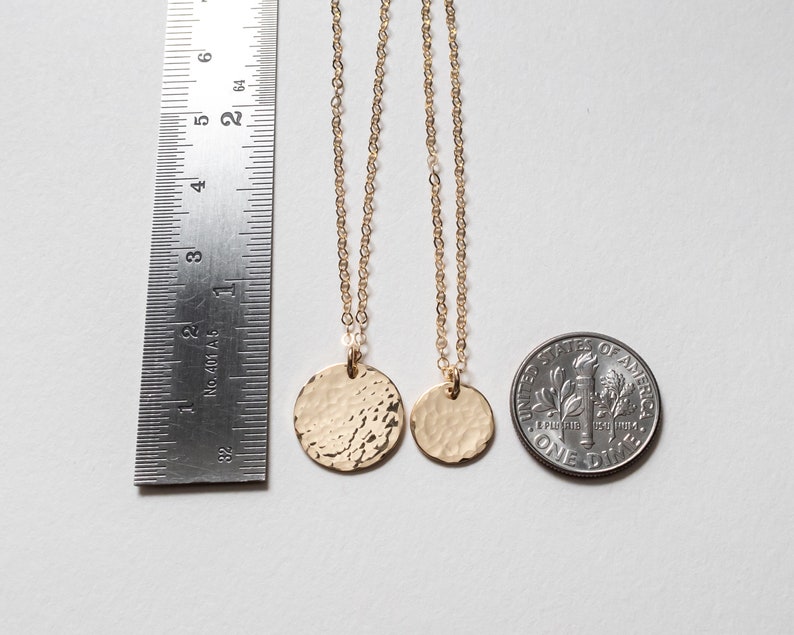 Both necklaces are shown next to a ruler and a dime, for size reference.