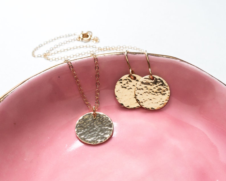 The larger disc necklace is shown with matching hammered dangle earrings.