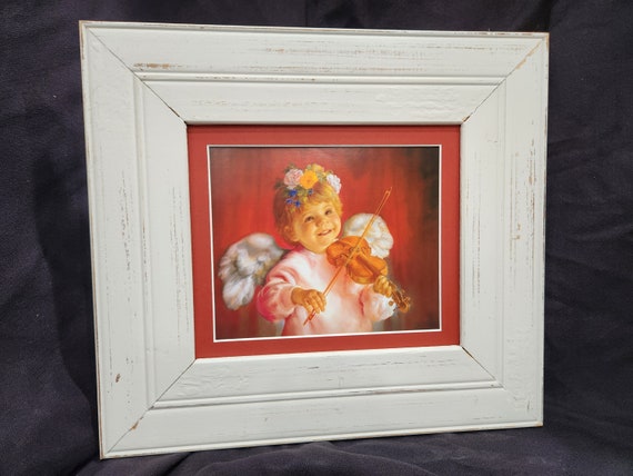 Baby Angel playing violin framed and matted print in white rustic frame.
