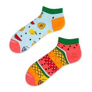 May include: A pair of colorful ankle socks with a fruit pattern. One sock features a blue background with watermelon, pineapple, and mango designs. The other sock has a red background with a watermelon and pineapple design.