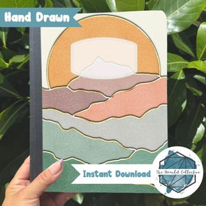 Pode incluir: Um caderno com um design de paisagem com um sol e montanhas em tons de laranja, pêssego e verde, com detalhes dourados. As palavras "Hand Drawn" e "Instant Download" são visíveis.