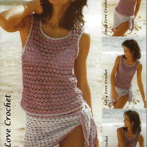May include: A lavender and white crochet drape vest and swing sarong. The sleeveless top and wrap skirt have an open weave. The text "Sassy Love Crochet" is visible. The outfit is suitable for the beach.