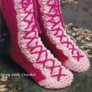 May include: Pink and white crocheted slippers with pink laces. The slippers are tied in a criss-cross pattern. Sassy Love Crochet.