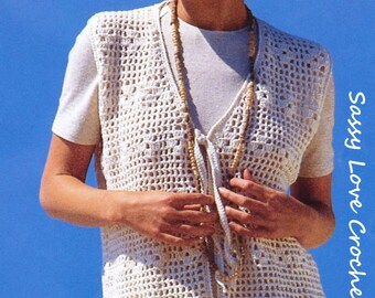 May include: A white crocheted vest with a tie closure and a wooden bead necklace. The vest is worn over a white t-shirt. "Sassy Love Crochet" is written in the bottom right corner of the image.