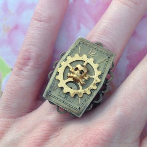 Ring adjustable COG and framing death's head clock