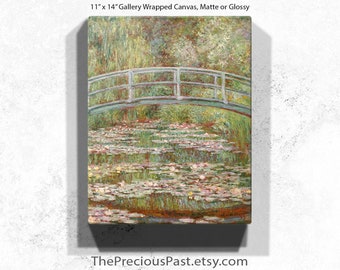 May include: An 11" x 14" gallery-wrapped canvas print of a painting depicting a serene water garden scene. The artwork features a green arched bridge over a pond filled with lily pads and flowers. The painting has a matte or glossy finish.