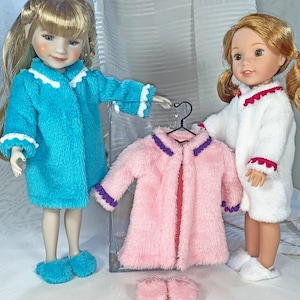May include: Two dolls wearing and displaying plush robes and slippers. One doll wears a turquoise robe with white trim, matching slippers. Another doll wears a white robe with red trim and white slippers. A pink robe with purple trim hangs on a hanger.