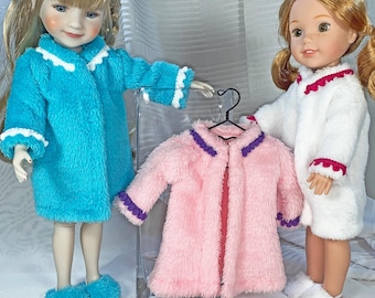 May include: Two dolls wearing and displaying plush robes and slippers. One doll wears a turquoise robe with white trim, matching slippers. Another doll wears a white robe with red trim and white slippers. A pink robe with purple trim hangs on a hanger.