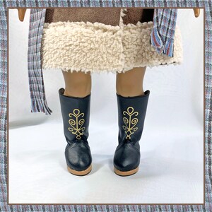 May include: Black leather boots with gold embroidery. The boots have a pointed toe and a low heel.