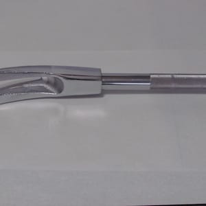 May include: A silver metal pry bar with a curved, forked head and a textured handle.