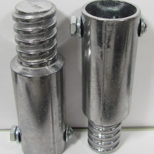 May include: Two silver metal pipe connectors with threaded ends and a screw-on design. The connectors are used to join pipes together.