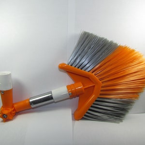 May include: Orange and gray angled broom with a telescopic handle. The handle has a white plastic connector and a white plastic base.