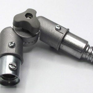 May include: A silver metal adjustable pipe fitting with a gray plastic knob. The fitting has a threaded end and a threaded connector. The knob allows for adjustment of the angle of the fitting.