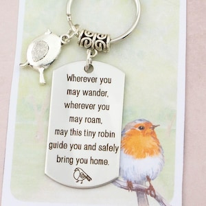 May include: Silver keyring with a bird-shaped charm and a rectangular tag. The tag is engraved with a poem about a robin guiding one home. A watercolour illustration of a robin is on the accompanying card.