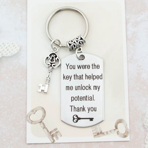 May include: Silver key chain with a tag that reads "You were the key that helped me unlock my potential. Thank you."  The tag has a small key design at the bottom.