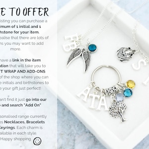 May include: A silver necklace with a charm that says "SID" and a charm that says "ATA" with a tree charm and birthstone charms. The necklace is in a white box with the text "MORE TO OFFER" and information about the product.