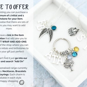May include: A silver necklace with a charm that says "SID" and a charm that says "ATA" with a tree charm and birthstone charms. The necklace is in a white box with the text "MORE TO OFFER" and information about the product.